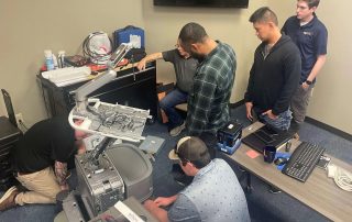 picture of a people repairing an ultrasound system